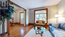 Living room with hardwood / wood-style flooring - 