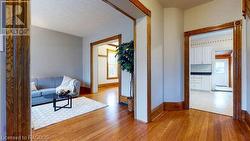 Hallway with a healthy amount of sunlight, a baseboard radiator, and light wood-type flooring - 