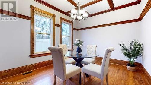 Dining space featuring hardwood / wood-style flooring, crown molding, and a notable chandelier - 550 10Th Street A West, Owen Sound, ON - Indoor Photo Showing Dining Room