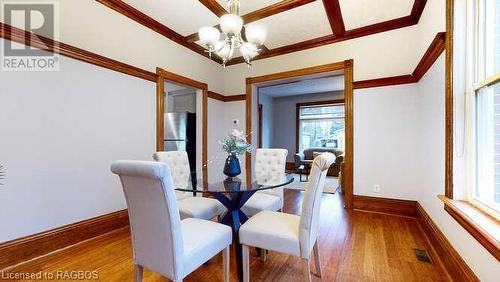 Dining area with hardwood / wood-style flooring, a notable chandelier, and crown molding - 550 10Th Street A West, Owen Sound, ON - Indoor Photo Showing Dining Room