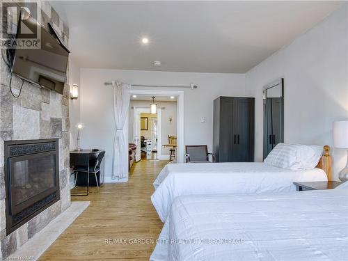 6039 Symmes Street, Niagara Falls, ON - Indoor Photo Showing Bedroom With Fireplace