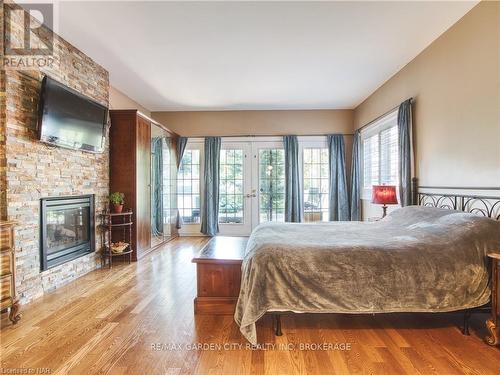 6039 Symmes Street, Niagara Falls, ON - Indoor Photo Showing Bedroom With Fireplace