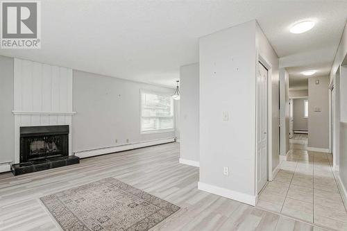 202, 219 Huntington Park Bay Nw, Calgary, AB - Indoor With Fireplace