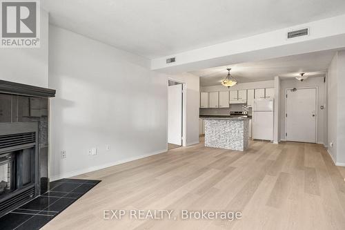 B07 - 120 Bell Farm Road, Barrie, ON - Indoor Photo Showing Other Room With Fireplace