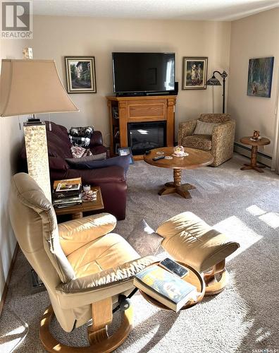 201 3140 Louise Street, Saskatoon, SK - Indoor Photo Showing Living Room With Fireplace