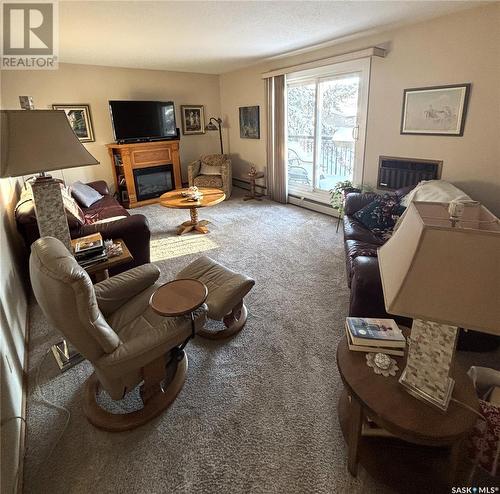 201 3140 Louise Street, Saskatoon, SK - Indoor Photo Showing Living Room With Fireplace