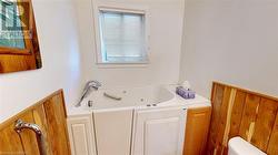 Walk in tub with seat and jets, heat lamp above - 