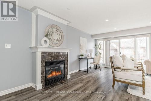 205 - 4 Beck Boulevard, Penetanguishene, ON - Indoor Photo Showing Living Room With Fireplace