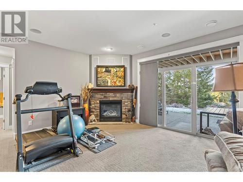 242 Dormie Place, Vernon, BC - Indoor Photo Showing Gym Room With Fireplace