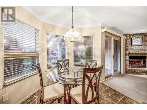 595 Yates Road Unit# 34 Lot# 76, Kelowna, BC - Indoor Photo Showing Dining Room With Fireplace