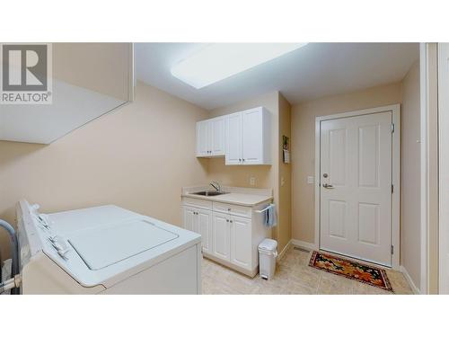 laundry room with entry into garage - 2365 Stillingfleet Road Unit# 10, Kelowna, BC - Indoor Photo Showing Laundry Room