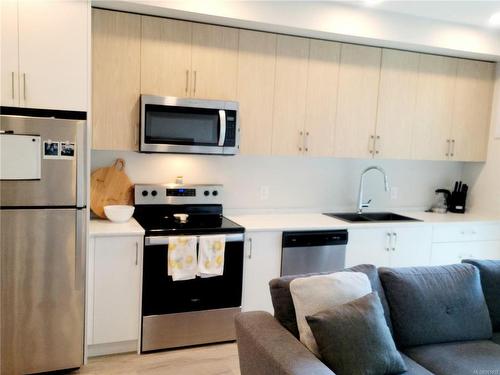 107-6544 Metral Dr, Nanaimo, BC - Indoor Photo Showing Kitchen With Stainless Steel Kitchen With Double Sink