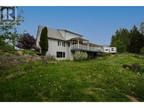 Fenced Backyard - 552 Wellspring Road, Creston, BC - Outdoor With Deck Patio Veranda