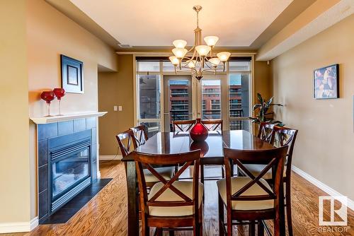 #1701 9020 Jasper Av Nw, Edmonton, AB - Indoor Photo Showing Dining Room With Fireplace