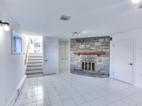 Basement - 10 37E Avenue, Bois-Des-Filion, QC - Indoor Photo Showing Living Room With Fireplace