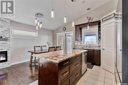 1231 Hargreaves Way, Saskatoon, SK - Indoor Photo Showing Kitchen With Fireplace