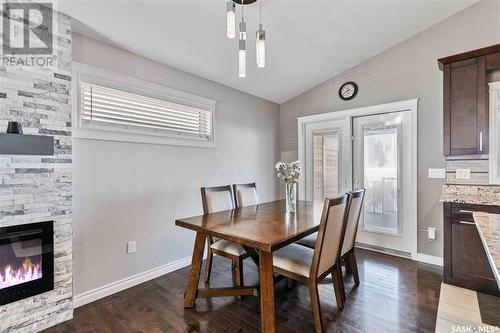 1231 Hargreaves Way, Saskatoon, SK - Indoor Photo Showing Dining Room With Fireplace