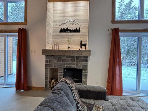 Living room - 180 Ch. Du Domaine-Roger, Lac-Supérieur, QC - Indoor With Fireplace