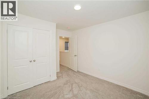 Unfurnished bedroom with light carpet and a closet - 182 Byers Street, London, ON - Indoor Photo Showing Other Room