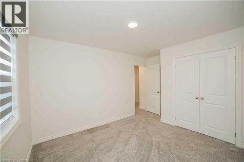 Unfurnished bedroom featuring light carpet and a closet - 182 Byers Street, London, ON - Indoor Photo Showing Other Room