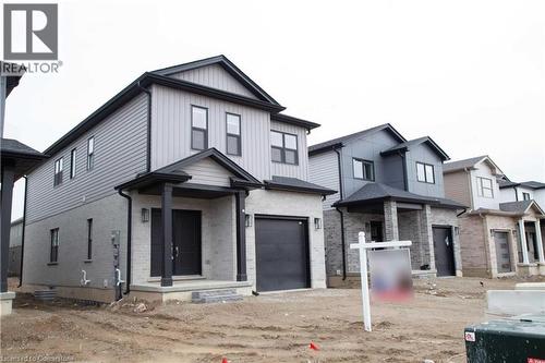 View of front of house with a garage - 182 Byers Street, London, ON - Outdoor With Facade