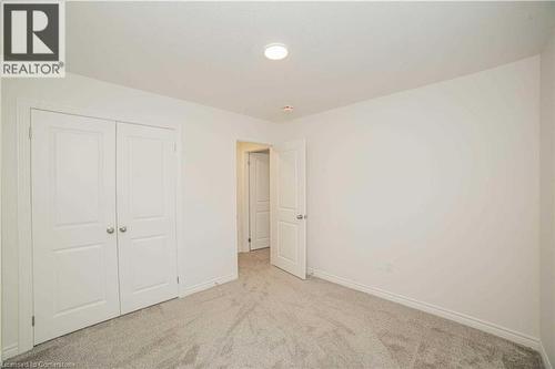 Unfurnished bedroom featuring light colored carpet and a closet - 182 Byers Street, London, ON - Indoor Photo Showing Other Room