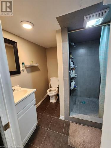 Bathroom featuring toilet, vanity, tile patterned floors, and walk in shower - 744-746 Queen Street S, Kitchener, ON - Indoor Photo Showing Bathroom