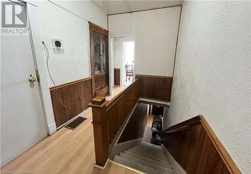 Stairs with hardwood / wood-style flooring and wooden walls - 744-746 Queen Street S, Kitchener, ON - Indoor Photo Showing Other Room