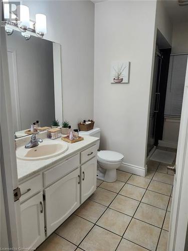 Bathroom with tile patterned floors, vanity, a shower with shower door, and toilet - 744-746 Queen Street S, Kitchener, ON - Indoor Photo Showing Bathroom