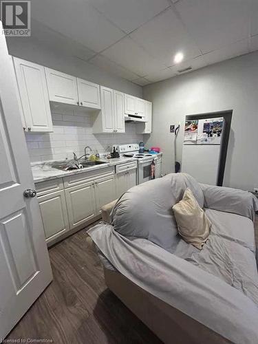 Bedroom featuring white fridge, dark hardwood / wood-style flooring, and sink - 744-746 Queen Street S, Kitchener, ON - Indoor Photo Showing Kitchen