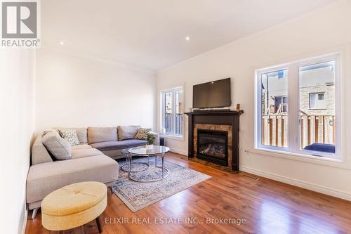 7 - 310 Southbrook Drive, Hamilton, ON - Indoor Photo Showing Living Room With Fireplace