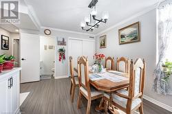 Dining space with a chandelier, wood-type flooring, and crown molding - 