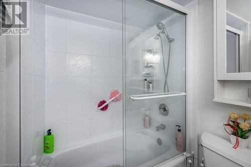 Bathroom with bath / shower combo with glass door and toilet - 3100 Kirwin Avenue Unit# 2102, Mississauga, ON - Indoor Photo Showing Bathroom