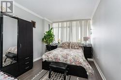 Bedroom with dark hardwood / wood-style flooring, a textured ceiling, and ornamental molding - 