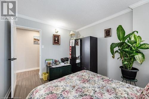 Bedroom featuring hardwood / wood-style floors, ornamental molding, and a textured ceiling - 3100 Kirwin Avenue Unit# 2102, Mississauga, ON - Indoor Photo Showing Bedroom