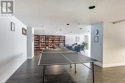 Rec room featuring dark hardwood / wood-style flooring and a textured ceiling - 