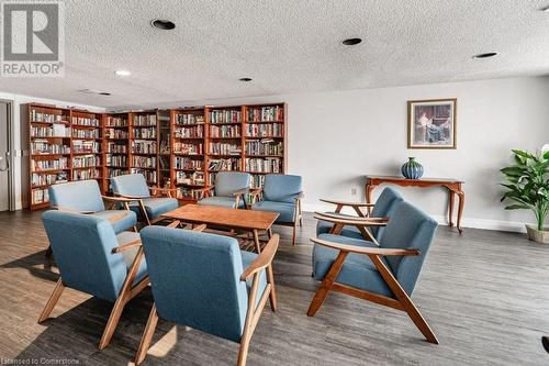 Living area featuring dark hardwood / wood-style flooring and a textured ceiling - 3100 Kirwin Avenue Unit# 2102, Mississauga, ON - Indoor