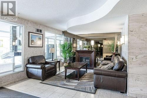 View of common area - 3100 Kirwin Avenue Unit# 2102, Mississauga, ON - Indoor Photo Showing Living Room With Fireplace