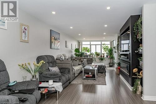 Living room with expansive windows and dark hardwood / wood-style flooring - 3100 Kirwin Avenue Unit# 2102, Mississauga, ON - Indoor Photo Showing Living Room