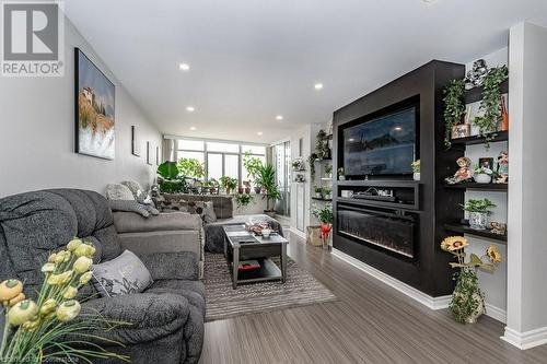 Living room featuring hardwood / wood-style flooring and floor to ceiling windows - 3100 Kirwin Avenue Unit# 2102, Mississauga, ON - Indoor Photo Showing Living Room