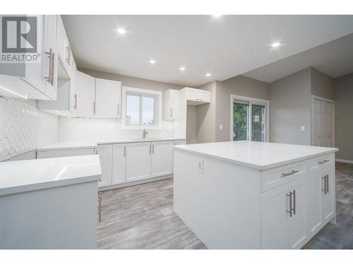 Lovely kitchen with island and tile backsplash - Suite - 2308 Thacker Drive, West Kelowna, BC - Indoor Photo Showing Kitchen