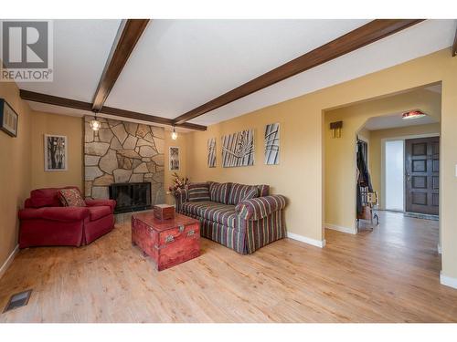 Main floor family room with cozy wood burning fireplace - 2308 Thacker Drive, West Kelowna, BC - Indoor Photo Showing Living Room With Fireplace