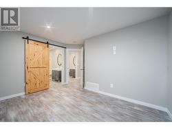 Primary bedroom with barn doors to the full ensuite bathroom - 