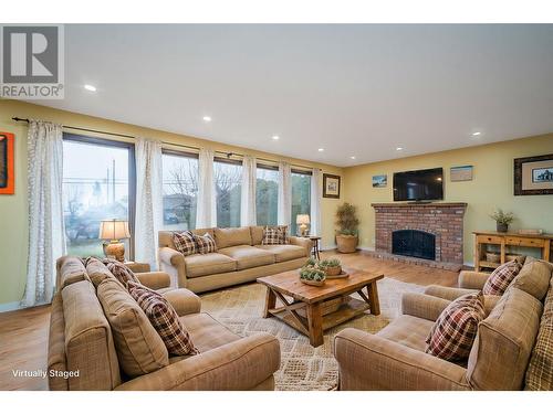 Living Room *This photo has been virtually staged* - 2308 Thacker Drive, West Kelowna, BC - Indoor Photo Showing Living Room With Fireplace