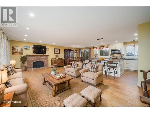 Great room *This photo has been virtually staged* - 2308 Thacker Drive, West Kelowna, BC - Indoor Photo Showing Living Room With Fireplace