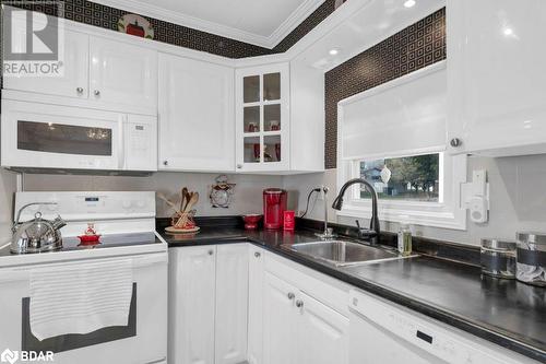 Kitchen featuring white appliances, white cabinetry, crown molding, and sink - 30 Kenneth Boulevard, Quinte West, ON - Indoor Photo Showing Kitchen