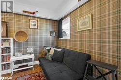 Living room with dark colored carpet and ornamental molding - 