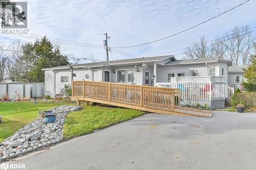 Ranch-style home featuring a wooden deck and a front lawn - 30 Kenneth Boulevard, Quinte West, ON - Outdoor