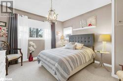 Carpeted bedroom featuring ornamental molding and a chandelier - 