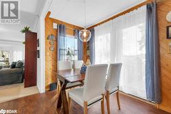 Dining space with wood-type flooring and wood walls - 